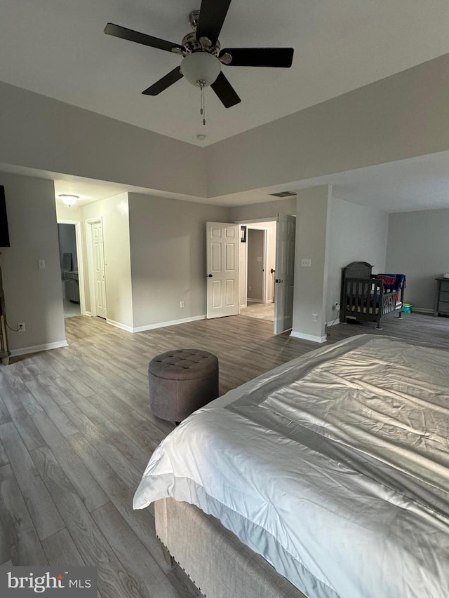 bedroom with wood-type flooring and ceiling fan