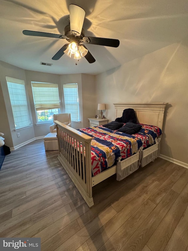 bedroom with hardwood / wood-style flooring and ceiling fan