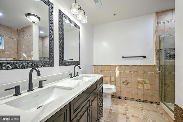 bathroom with toilet, walk in shower, vanity, and tile walls