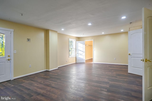 unfurnished room with dark wood-type flooring