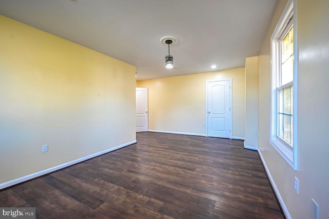 spare room featuring dark hardwood / wood-style flooring