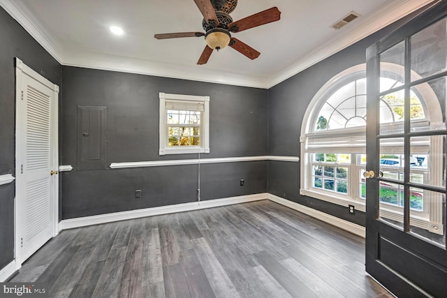 empty room featuring crown molding, hardwood / wood-style flooring, electric panel, and ceiling fan