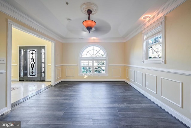 entrance foyer featuring crown molding, plenty of natural light, and dark hardwood / wood-style floors