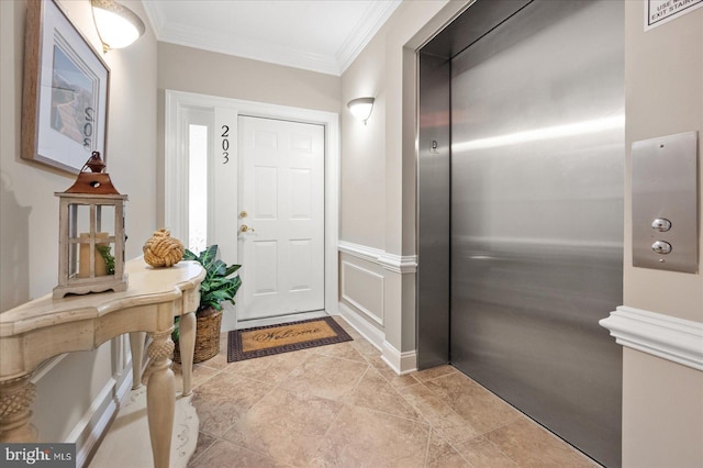 foyer entrance featuring crown molding and elevator