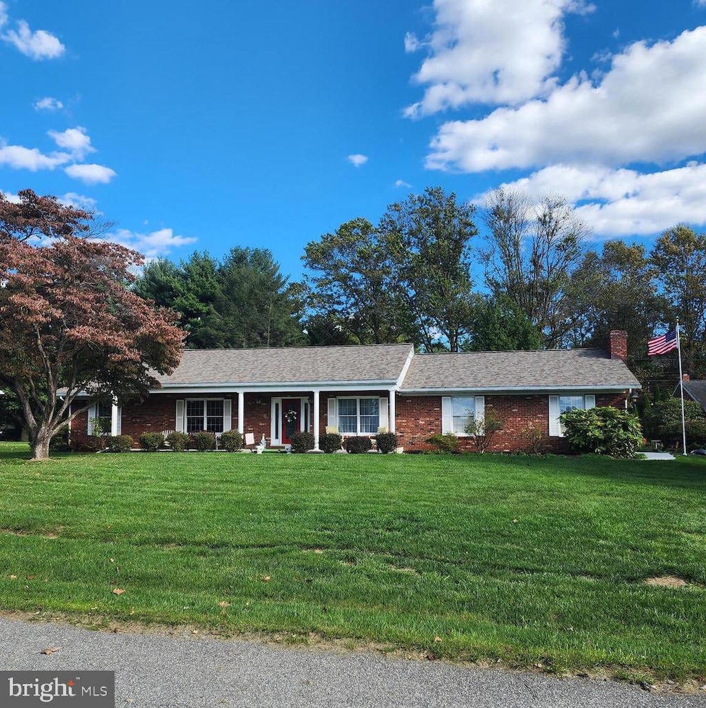 ranch-style house with a front lawn