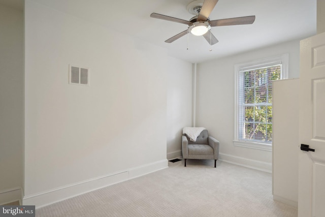 unfurnished room with ceiling fan and light carpet