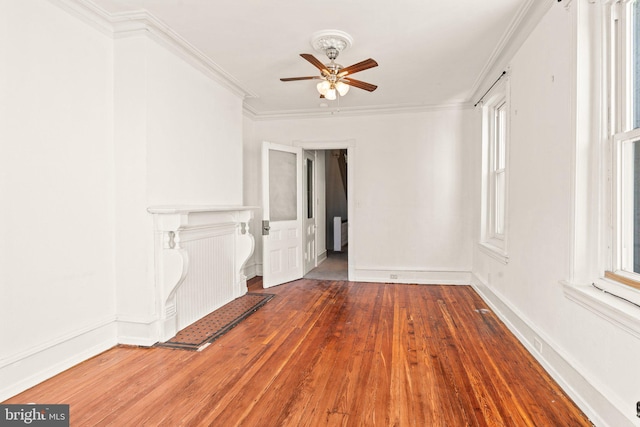 unfurnished living room featuring hardwood / wood-style flooring, crown molding, and ceiling fan