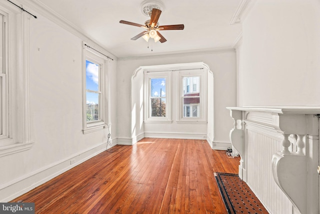 unfurnished living room featuring ceiling fan, crown molding, and light hardwood / wood-style flooring