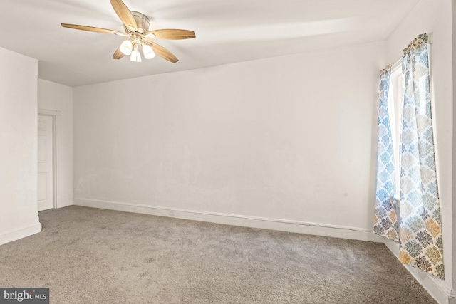 spare room with carpet floors and ceiling fan