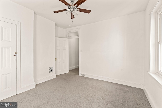 unfurnished bedroom with light colored carpet and ceiling fan