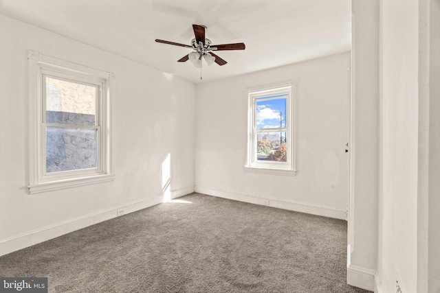 spare room featuring ceiling fan and carpet floors