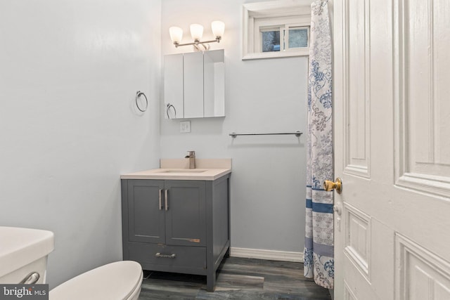 bathroom featuring hardwood / wood-style flooring, vanity, and toilet