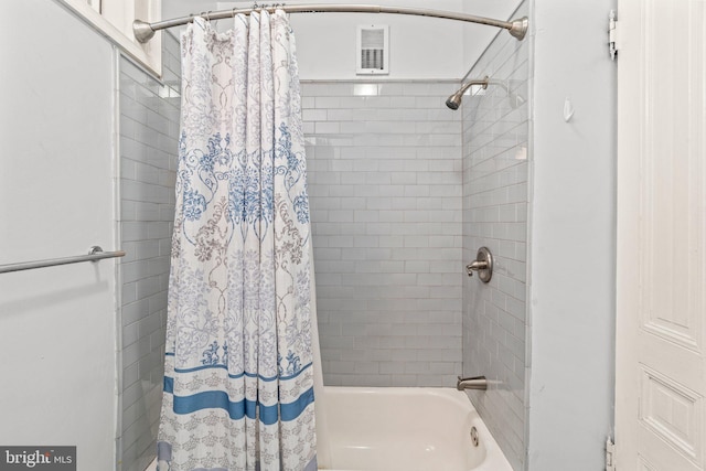 bathroom with shower / bath combination with curtain