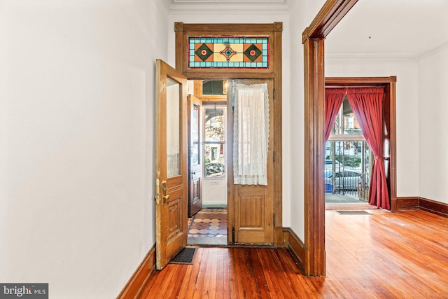 foyer entrance featuring hardwood / wood-style floors and crown molding