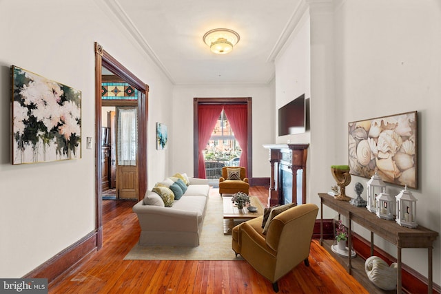 living room featuring wood-type flooring and crown molding