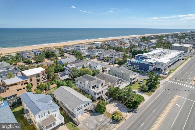 aerial view with a water view and a beach view