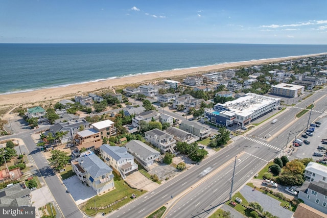 drone / aerial view with a water view and a view of the beach