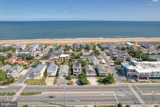 birds eye view of property featuring a water view and a view of the beach