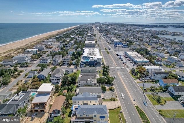 drone / aerial view featuring a water view and a beach view