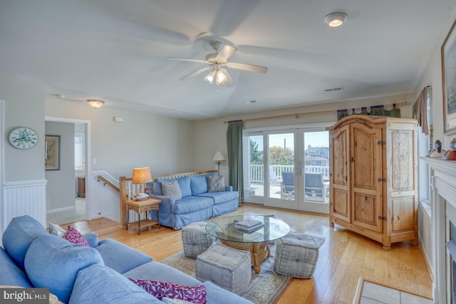 living room featuring french doors, light hardwood / wood-style flooring, and ceiling fan