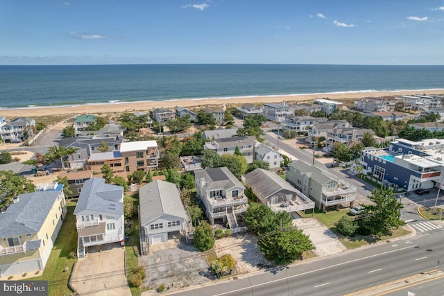 drone / aerial view featuring a water view and a beach view