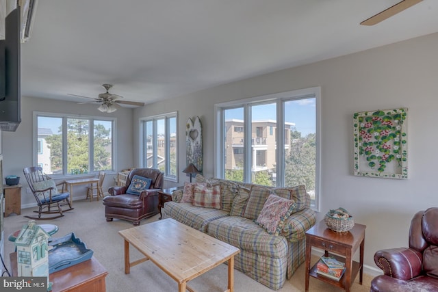 living room featuring carpet floors, a wealth of natural light, and ceiling fan