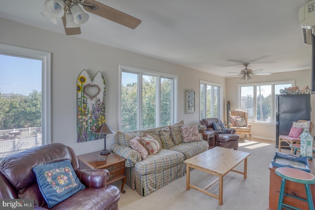 carpeted living room featuring ceiling fan and a healthy amount of sunlight