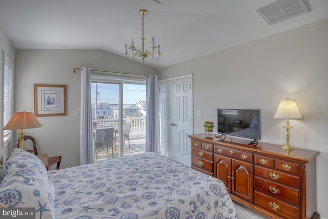 carpeted bedroom featuring a notable chandelier, a closet, vaulted ceiling, and access to outside