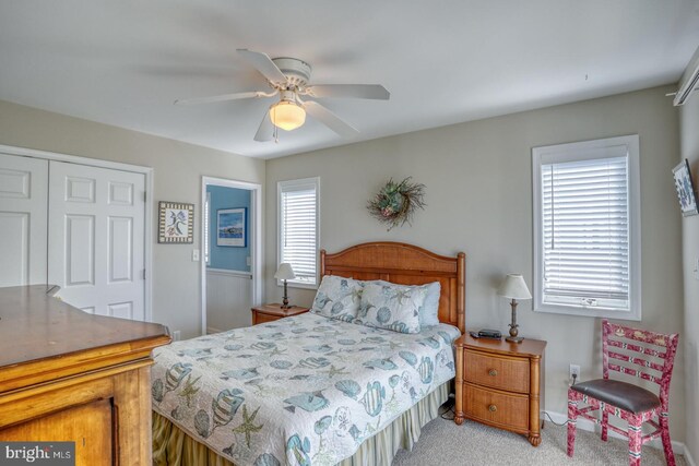 carpeted bedroom featuring ceiling fan and a closet