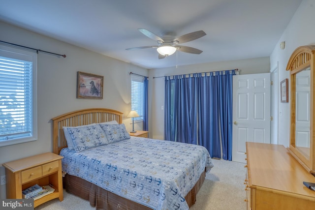 bedroom with ceiling fan and light colored carpet