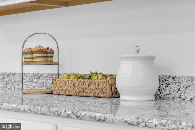 interior details with light stone countertops and backsplash