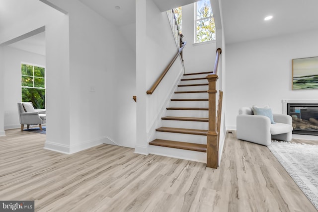 staircase with hardwood / wood-style flooring and plenty of natural light