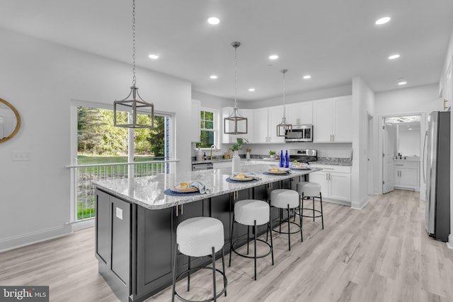 kitchen with white cabinetry, recessed lighting, a spacious island, and appliances with stainless steel finishes