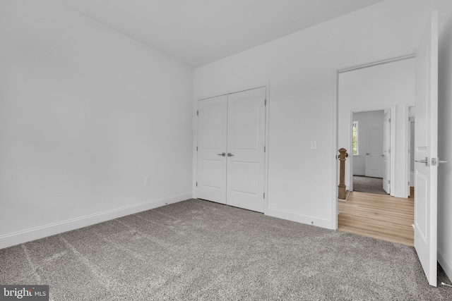 unfurnished bedroom featuring a closet, baseboards, and carpet floors
