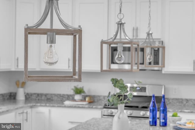 kitchen featuring white electric range oven and white cabinets