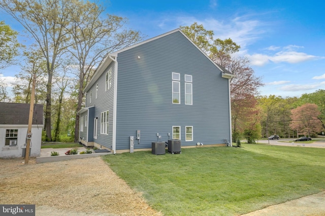 view of property exterior with a lawn and central AC