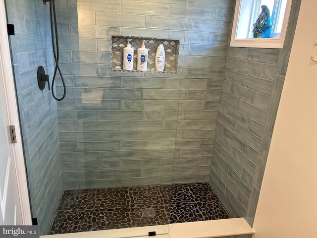 bathroom with a tile shower