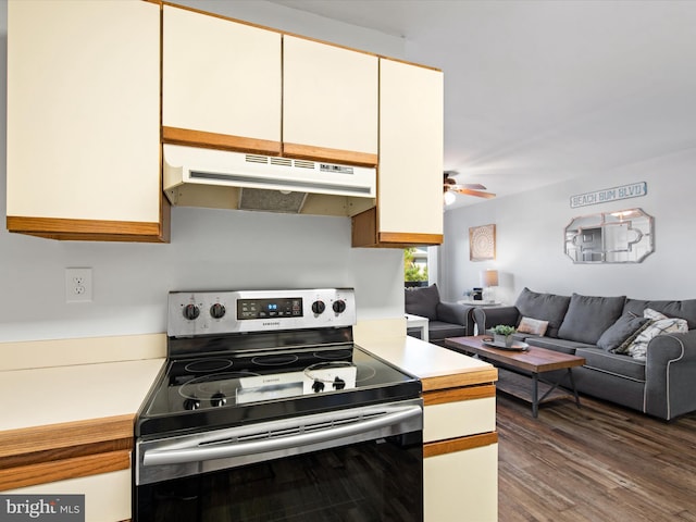 kitchen featuring stainless steel range with electric cooktop, white cabinets, dark hardwood / wood-style flooring, and ceiling fan