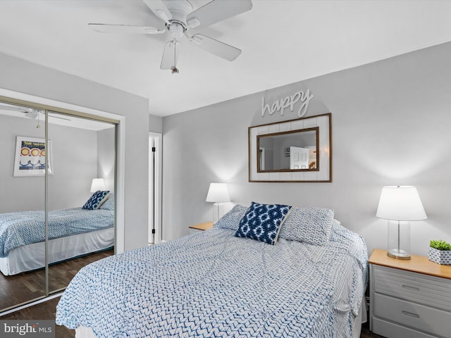 bedroom featuring ceiling fan, dark wood-type flooring, and a closet