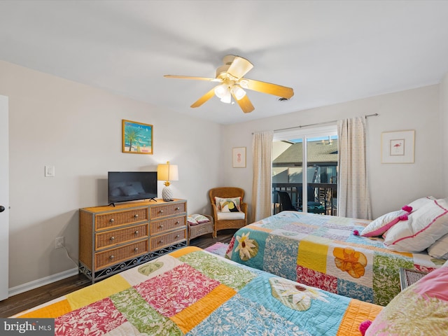 bedroom featuring access to outside, dark hardwood / wood-style flooring, and ceiling fan