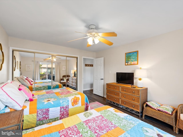 bedroom featuring ceiling fan, a closet, and dark hardwood / wood-style flooring