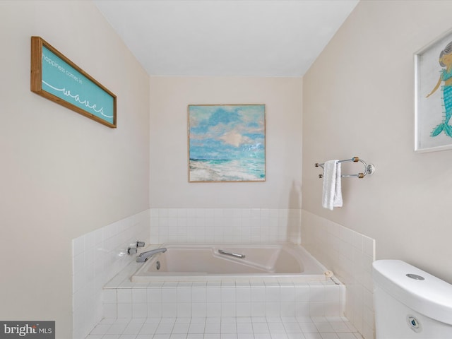 bathroom with tiled tub and toilet