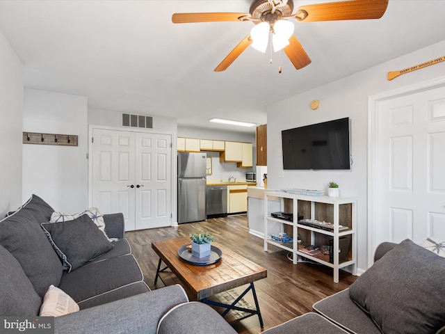 living room with sink, dark hardwood / wood-style flooring, and ceiling fan