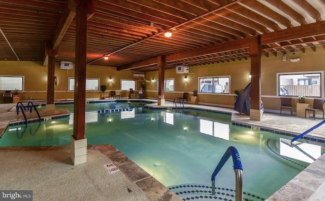 view of swimming pool with a hot tub