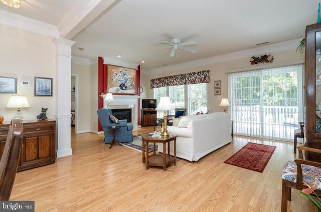 living room featuring ornate columns, ornamental molding, light wood-type flooring, and ceiling fan