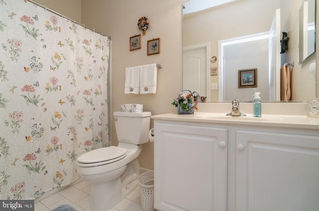 bathroom with vanity, toilet, and tile patterned flooring