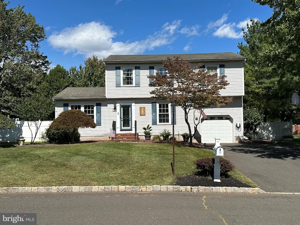 view of front of house featuring a garage and a front lawn