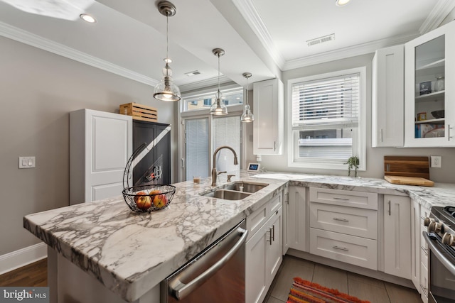 kitchen featuring light stone counters, sink, white cabinetry, stainless steel appliances, and crown molding