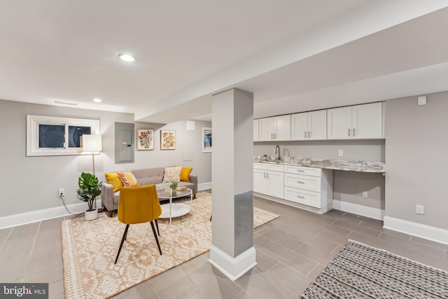 living room with electric panel and sink