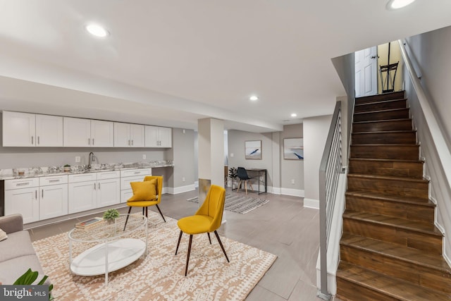 interior space featuring light stone countertops, hardwood / wood-style floors, and white cabinets